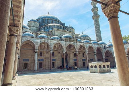 Exterior view of Suleymaniye Mosque through arches in its courtyard in Istanbul Turkey. The mosque was constructed by Sinan for sultan Suleyman the Magnificent