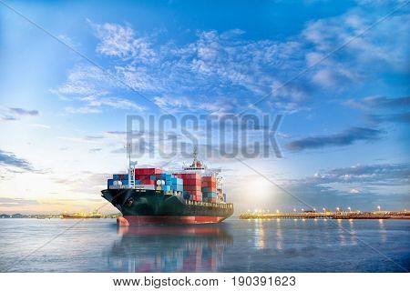 Logistics and transportation of International Container Cargo ship in the ocean at twilight sky Freight Transportation Shipping