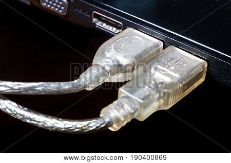 USB cable. Two jacks with plugs inserted USB Translucent cable. Communication technology. Icons on the cable.