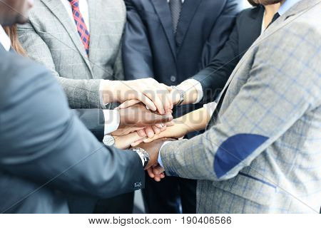 Businessman team in suit touching hands together. Selective focus