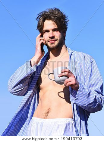 Caucasian Macho In Blue Striped Pajamas Holding Cup