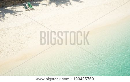 Beach tropical with two relaxing chair white sandy and crystal water seen from above. Rawa island Malaysia .
