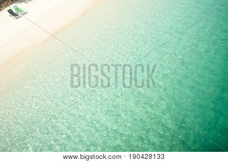 Beach tropical with two relaxing chair white sandy and crystal water seen from above. Rawa island Malaysia .
