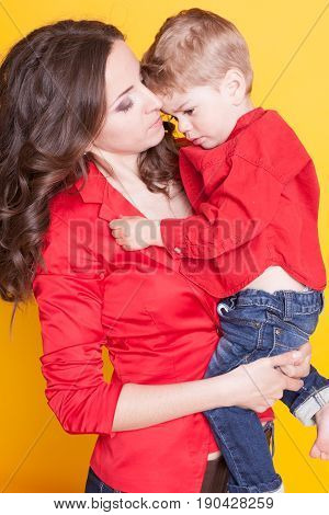 mother and son in red shirts on a yellow background