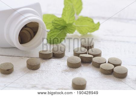 herb pill on top view of wood table and copy space