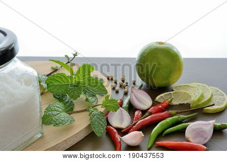 Asian cuisine ingredients food top view spice lemon onion garlic chili pepper mint salt for cooking original eastern foods style on wood texture and white background Thailand food spices