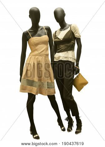 Two full-length female mannequins dressed in fashionable clothes isolated on white background. No brand names or copyright objects.