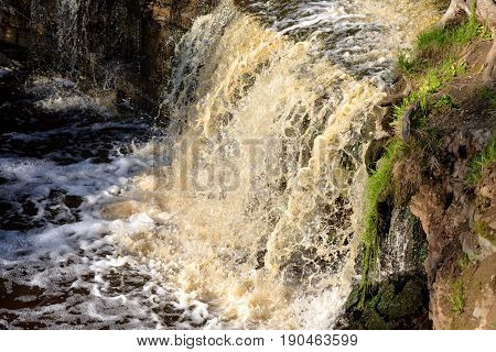 Small waterfall at sunny summer day Russia.