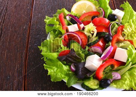 Fresh vegetables on wooden and blur background.