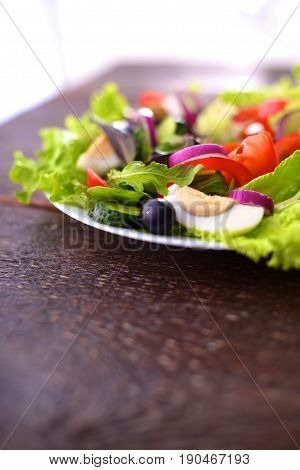 Fresh vegetables on wooden and blur background.