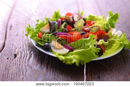 Fresh vegetables on wooden and blur background.