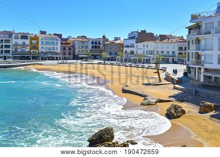 ESCALA, SPAIN - APRIL 20, 2017: A view of La Patja beach, one of the main beaches in the old town of this village, belonging to the Costa Brava, a popular summer destination in Catalonia, Spain
