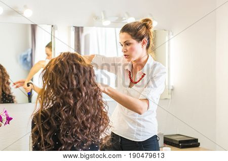 Hairdresser doing haircut for women in hairdressing salon. Concept of fashion and beauty. Positive emotion