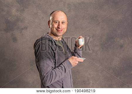 Young Baldheaded Man Drinking Coffee