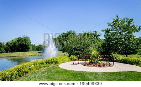 Tranquil rest area in front of a pond with a large fountian