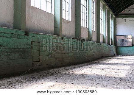 Abandoned riding hall without horses and horsemen