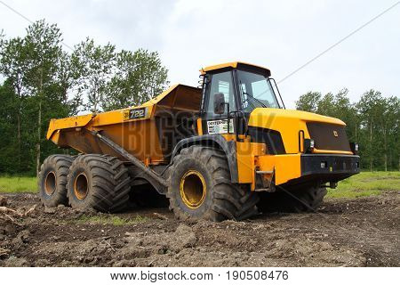 Almere Poort, Flevoland, The Netherlands - June 10, 2017: Yellow JCB 722 Articulated Dump Truck parked on a construction site in the city of Almere. Nobody in the dumper.