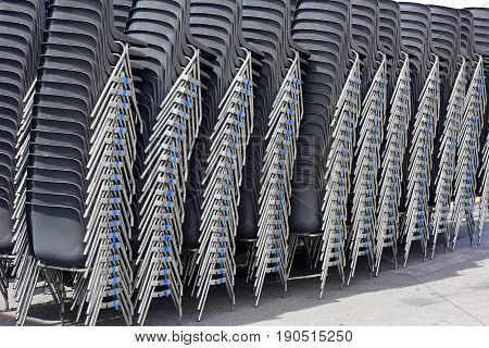 Black plastic chairs used for square events