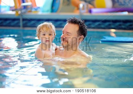 Happy Smiling Little Boy With His Father In Swimming Pool