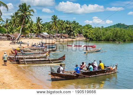Ambatozavavy Nosy Be Madagascar - December 19 2015: Traditional wood pirogue with outrigger waiting for passengers in the fishing Ambatozavavy village on the Nosy Be island Madagascar.