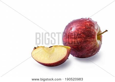 Fresh red apple (Malus domestica Malus pumila or Pyrus malus) with drops of water and a quarter of fresh apple with seeds isolated on white background