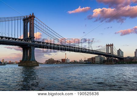 Manhattan Bridge (long-span suspension bridge) over the East River at sunset with view of Brooklyn. New York City