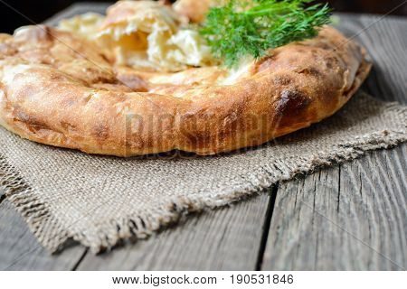 Pita flatbread,. traditional asian bread on wooden background