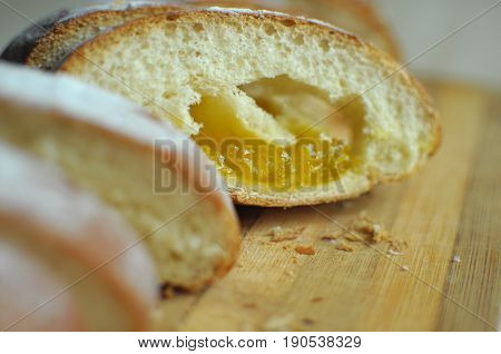 Cut pineapple pie with slices on a stripped cutting board. Close up