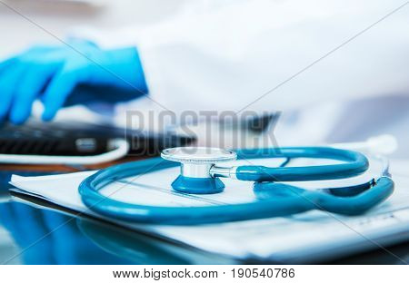 Medical Doctor Office. Closeup on a Stethoscope Lying on the Doctors Desk.