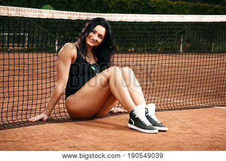 Beautiful Young Free Sports Sexy Girl Dressed In Bodysuit, Sneakers, With A Smart Ass And Long Legs,