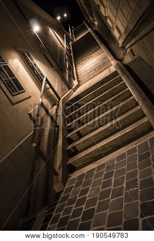 Stairs in a narrow alley at night