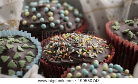 Close-up Of Cupcakes With Chocolate Icing And Sugar Decorations
