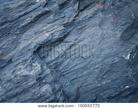 Dark blue slate background or texture. Blue rock.