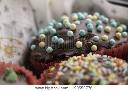 Close-up Of Cupcakes With Chocolate Icing And Sugar Decorations
