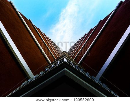 Bottom view of hotel building balconies with blue sky