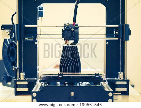 The process of working 3D printer and creating a three-dimensional object. Progressive modern additive technology. 4ht industrial revolution.