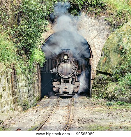 Steam narrow-gauge train moves from Yuejin to Bagou through the tunnel. Jiayang Mining Region. Sichuan province. China.