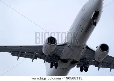 The underside of a modern airplane and its landing gear