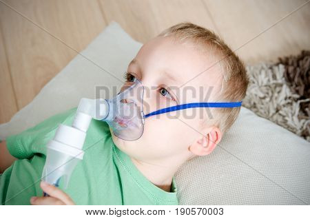 Boy Making Inhalation With Nebulizer At Home