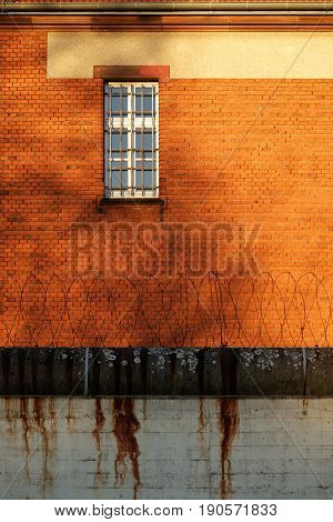 The outside view of an old and abandoned jail in Berlin during sunset