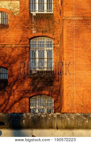 The outside view of an old and abandoned jail in Berlin during sunset