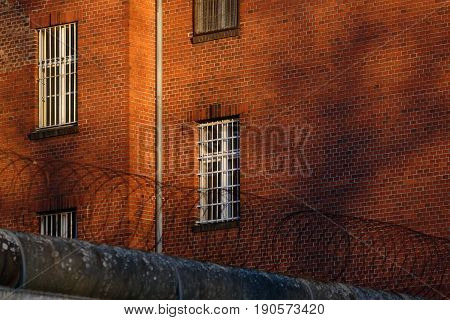 The outside view of an old and abandoned jail in Berlin during sunset