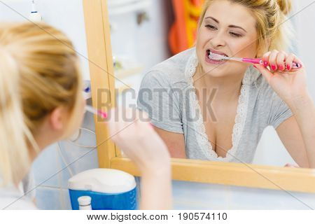 Woman Brushing Cleaning Teeth In Bathroom