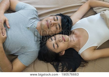 Top View Of Romantic Young Couple Lying In Bde