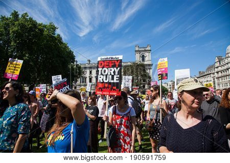 London, UK - June 10 2017: Unidentified protesters  at Westminster Palace expressing their anger at Theresa May's government and her alliance with the Democratic Unionist Party, London, UK