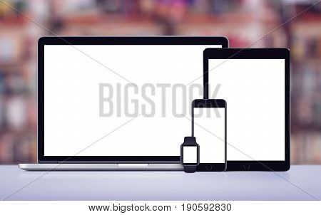 Laptop, tablet pc, smartphone and smartwatch responsive design mockup on office desk.