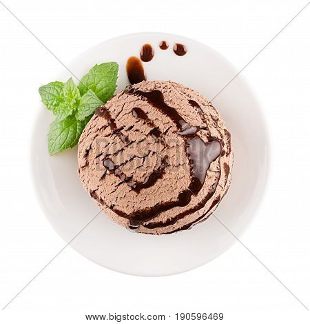 Ice cream brown scoop on plate decorated mint leaves chocolate sauce top view isolated on white background.