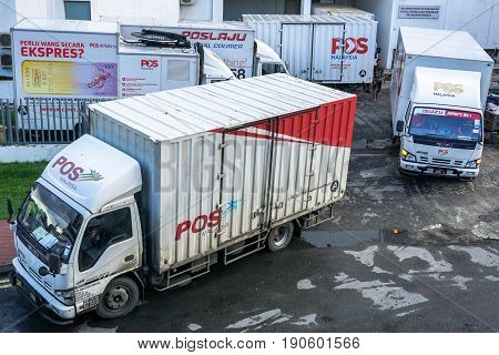 Kota Kinabalu,Sabah-May 27,2017:Poslaju Express trucks on a parking lot in Kota Kinabalu,Sabah,Malaysia.Pos Laju is the leading courier company & has the widest network coverage & the largest courier fleet in Malaysia.