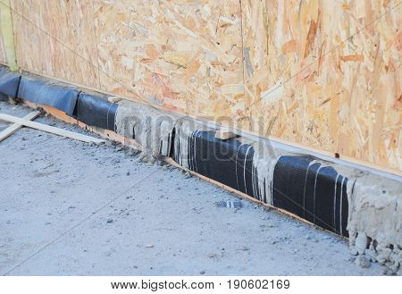 Waterproofing basement SIP panel walls. Sip House foundation waterproofing with bitumen membrane. Bituminous waterproofing.