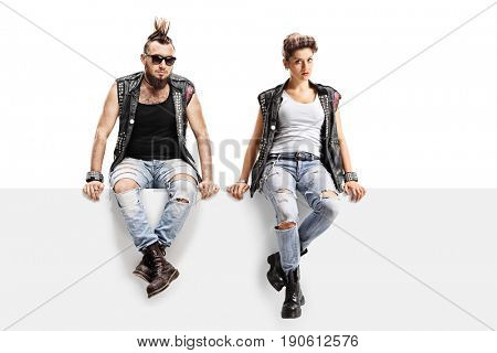 Male and female punkers sitting on a panel isolated on white background